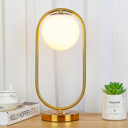 Lampe de chevet boule en verre et métal doré