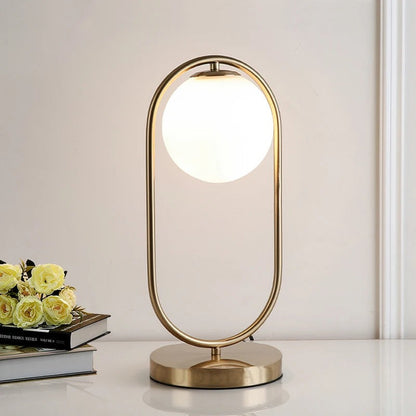 Lampe de chevet boule en verre et métal doré