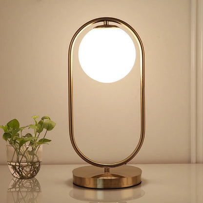 Lampe de chevet boule en verre et métal doré